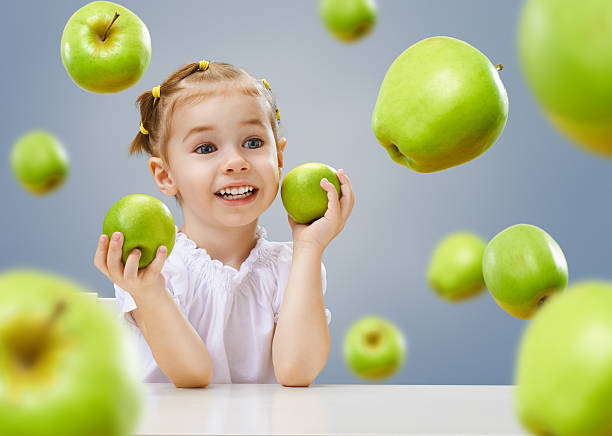 Young woman and flying apples
