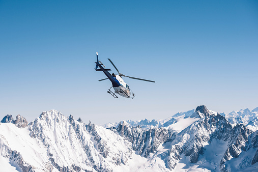 Helicopter flying over the Alps
