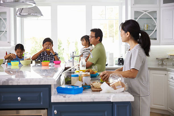istock Family Having Breakfast And Making Lunches In Kitchen 538044638