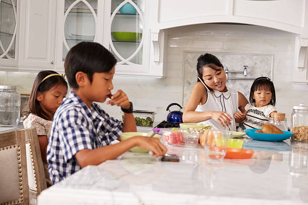 istock Busy Mother Organizing Children At Breakfast In Kitchen 538044892