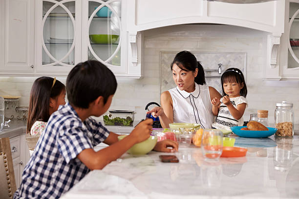 istock Busy Mother Organizing Children At Breakfast In Kitchen 538044910