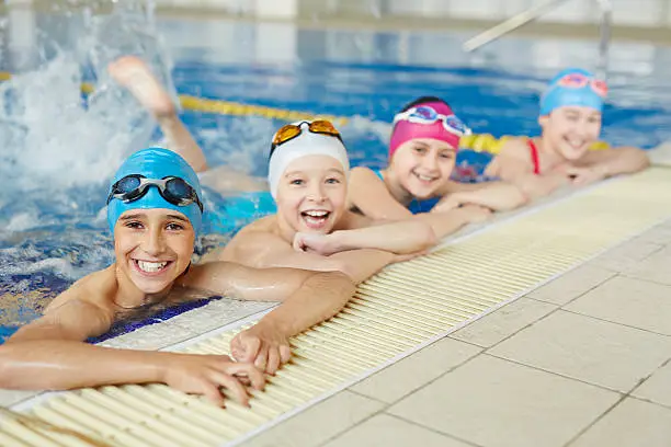 Happy group of children swimming together