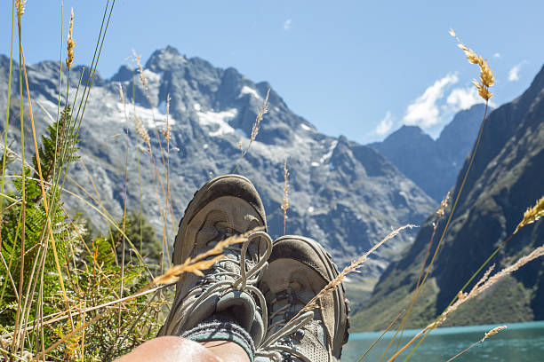 istock Woman's legs and hiking boots on rock at Lake Marian 538045948