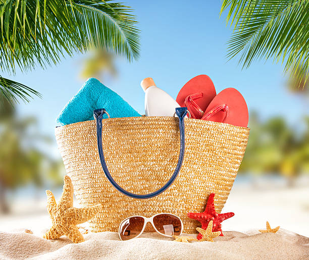 Beach accessories on tropical island Summer concept of beach relaxation with accessories for sunbathing beach bag stock pictures, royalty-free photos & images