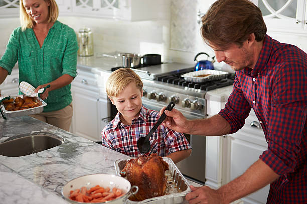 istock Family Preparing Roast Turkey Meal In Kitchen Together 538048028