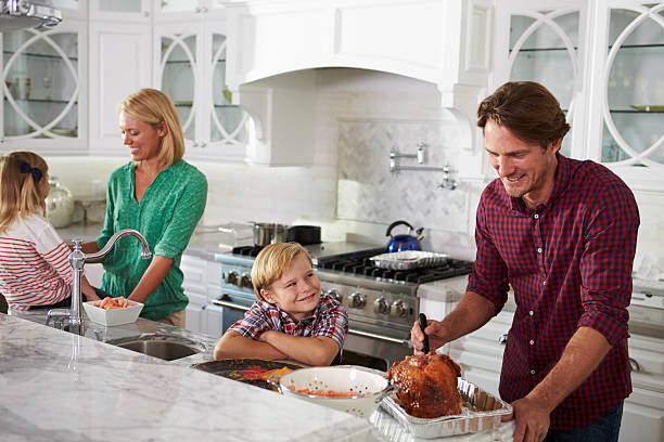 istock Family Preparing Roast Turkey Meal In Kitchen Together 538048066