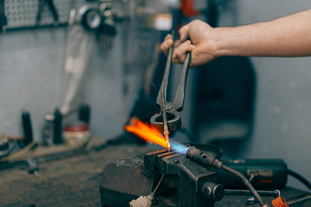 Metalworker working with torch and repair metal. Metalworker working with torch and repair metal. Selective focus and small depth of field. oxyacetylene stock pictures, royalty-free photos & images