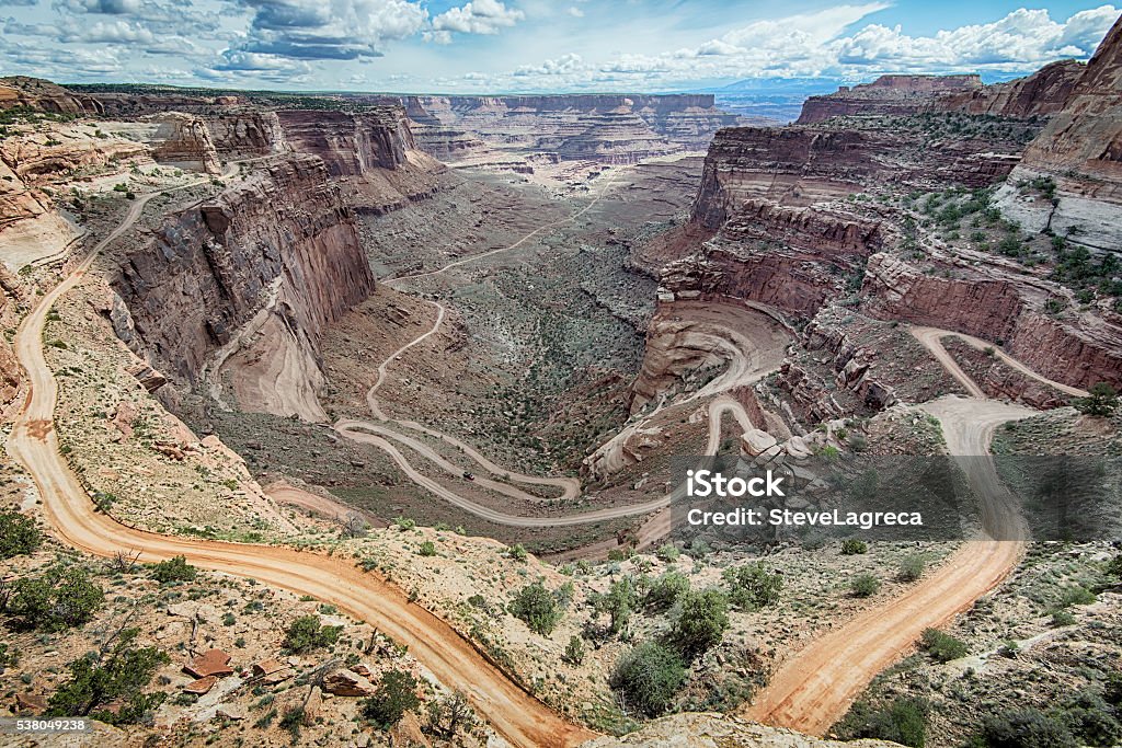 Shafer Switchbacks, Canyonlands National Park, UT A 4WD vehicle makes its way down a dirt road through the Shafer Switchbacks, in the Islands in the Sky District of Canyonlands National Park, near Moab, Utah. Dirt Road Stock Photo