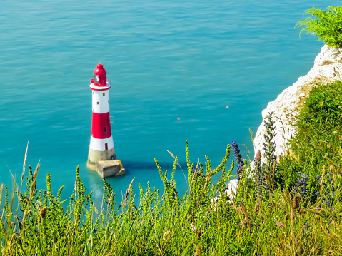 White chalk cliffs and Beachy Head Lighthouse. Eastbourne, East Sussex, England. Selective focus