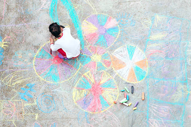young kid playing with chalk. - playground schoolyard playful playing imagens e fotografias de stock