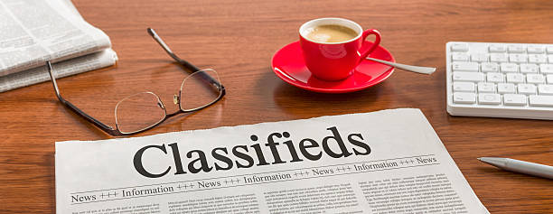 istock Newspaper on a wooden desk - Classifieds 538051284