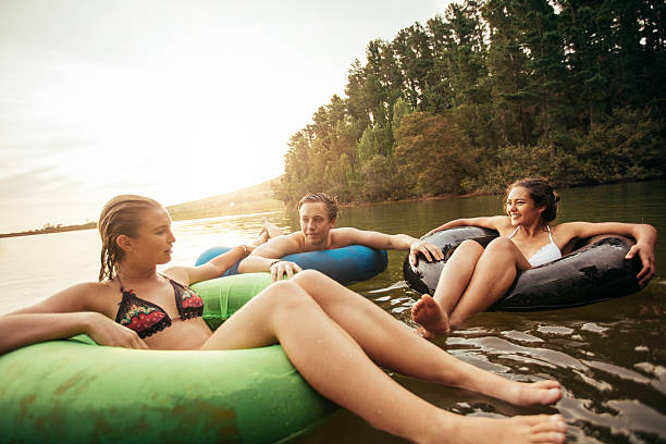istock Friends floating on lake with inflatable rings 538052532