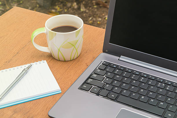 istock Cup of coffee with  laptop and a notebook on table. 538052854