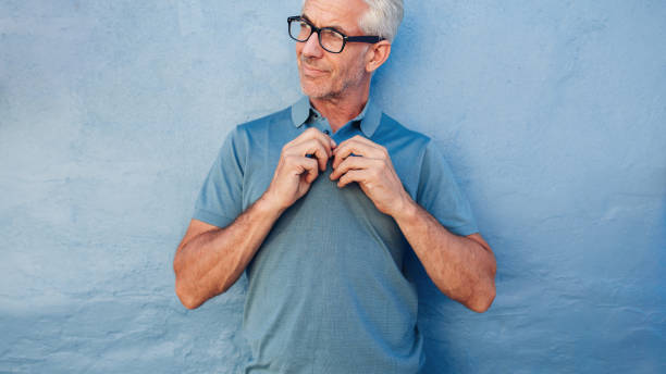 istock Handsome mature man buttoning up his tshirt 538053360