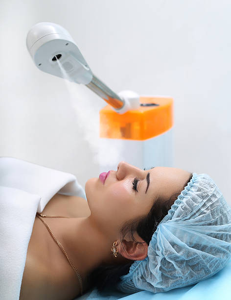 istock Woman getting steam on her face in spa. 538054248