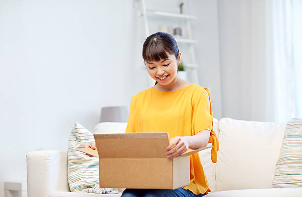 istock happy asian young woman with parcel box at home 538054540