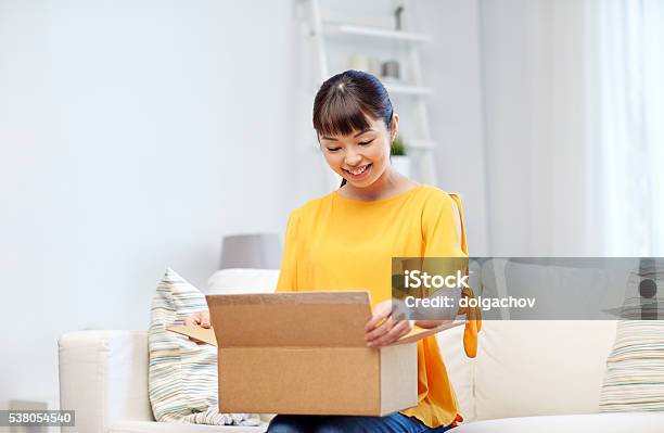 Happy Asian Young Woman With Parcel Box At Home Stock Photo - Download Image Now - Box - Container, Package, Opening