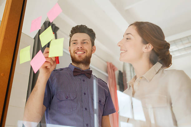 istock creative team with stickers on glass at office 538055616