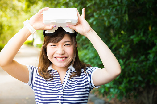 A young Japanese Girl Enjoying Virtual Reality Console at a Cafe in Kyoto, Japan.