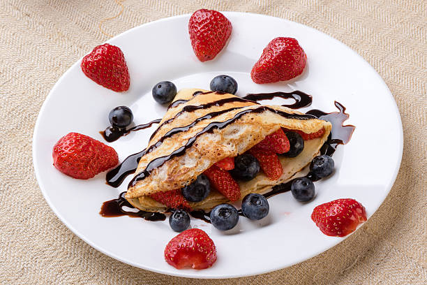 pancake with fruits and chocolate syrup stock photo
