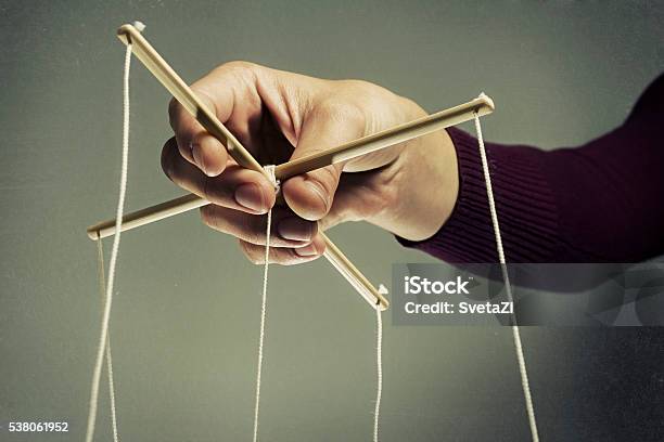 Manipulating Arm Stock Photo - Download Image Now - Puppet, Under The Thumb, Puppeteer