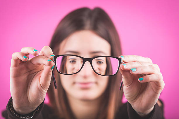 istock Young Woman with Eyesight Problems on Fuchsia Background. 538064371