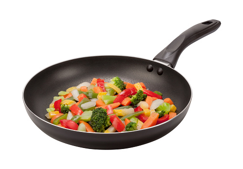  Stir Fry Vegetables cooking in a black nonstick pan. The lighting is soft, and comes from the upper left. The vegetables include carrots, squash, green beans, and onions. The image is shown at an angle, and is in full focus from front to back, achieved by stacking multiple exposures. The image is isolated on a white background, and includes a clipping path. This photo was shot with a Canon EOS-1 Ds Mark 2.
