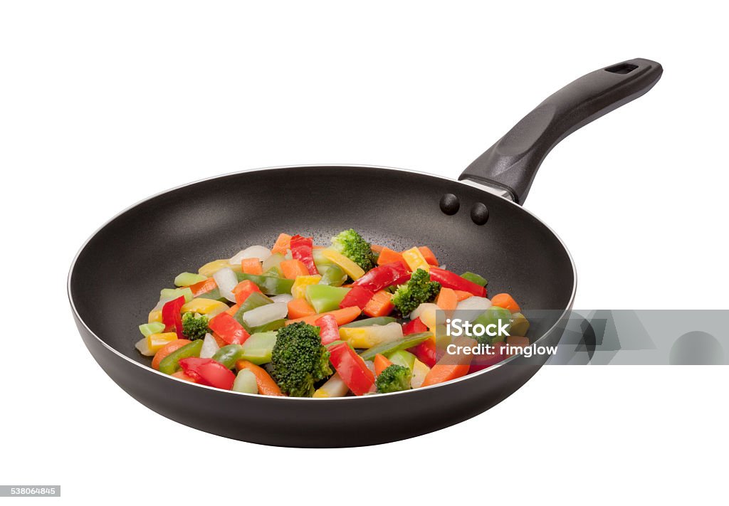 Stir Fry Vegetables in a Pan with clipping path  Stir Fry Vegetables cooking in a black nonstick pan. The lighting is soft, and comes from the upper left. The vegetables include carrots, squash, green beans, and onions. The image is shown at an angle, and is in full focus from front to back, achieved by stacking multiple exposures. The image is isolated on a white background, and includes a clipping path. This photo was shot with a Canon EOS-1 Ds Mark 2. Cooking Pan Stock Photo