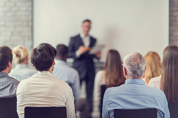 Business people attending a seminar.