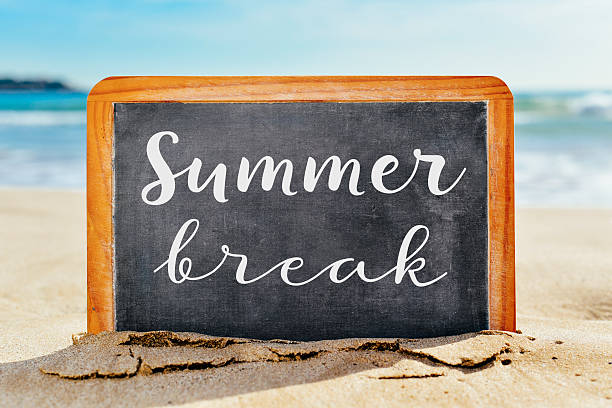 istock text summer break in a chalkboard, on the beach 538065154