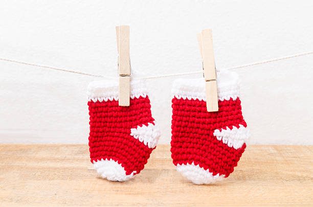 istock Knitted baby socks hanging on the clothesline 538065198
