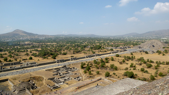 San Juan Teotihuacan, State of Mexico, Mexico - January 03, 2013: View of Teotihuacan from the Pyramid of the Sun, the Avenue of the Dead and the Pyramid of the Moon in background. Teotihuacan is a Unesco World Heritage Site  and also known as the City of the Gods.