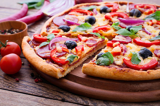 istock Delicious pizza served on wooden table 538066381