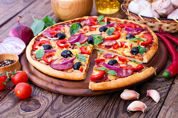 istock Delicious pizza served on wooden table 538066389