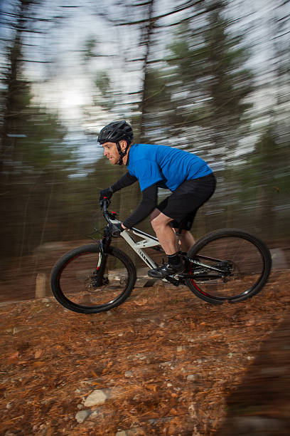 istock Mountain biker descending a trail at speed in the woods 538067362