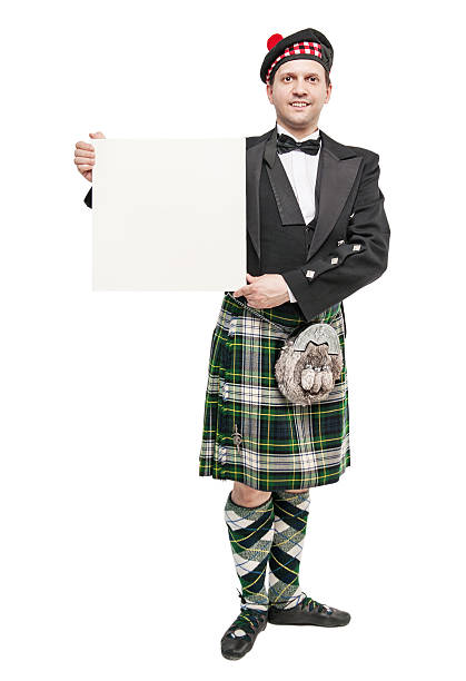 istock Young man in clothing for Scottish dance with empty banner 538068324