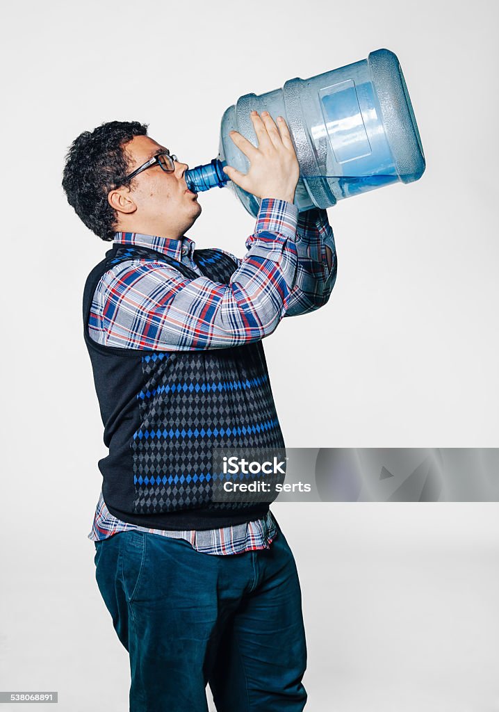 Fatman drink water Portrait of Funny fat young man drinking water with large water bottle on white background Drinking Stock Photo