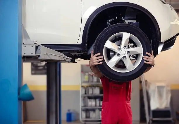 Photo of mechanic behind tire