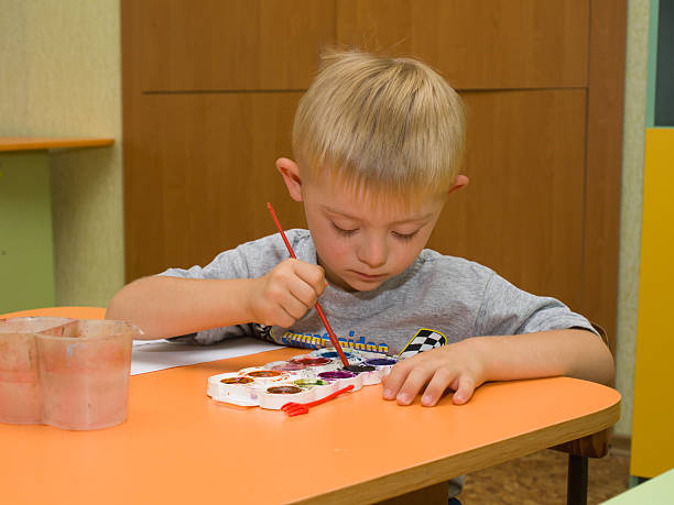 istock Child with Down syndrome is drawing 538069988