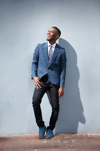 Full length portrait of a young business man laughing outdoors