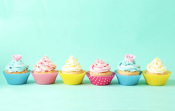 istock Birthday cupcakes on green background 538070525