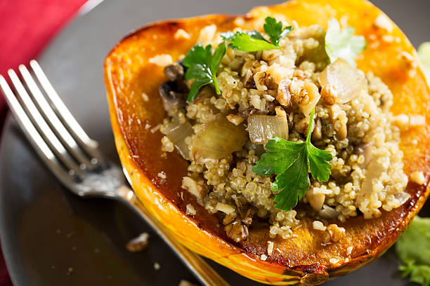 Stuffed Winter Squash Winter Squash stuffed with quinoa, mushrooms and onions. Acorn Squash stock pictures, royalty-free photos & images