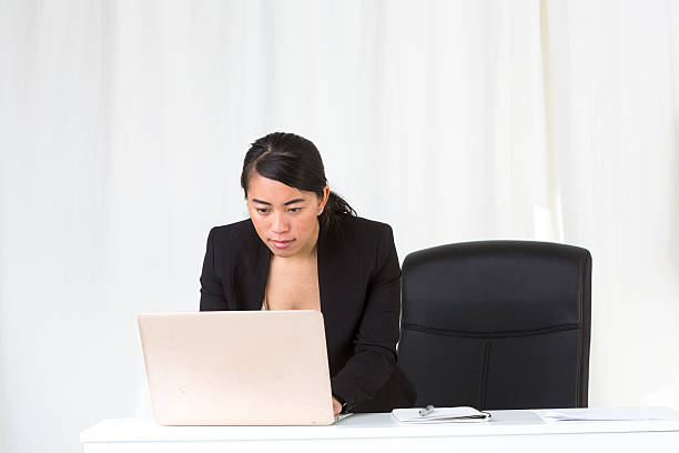 istock Asian employee looking at computer monitor 538070774