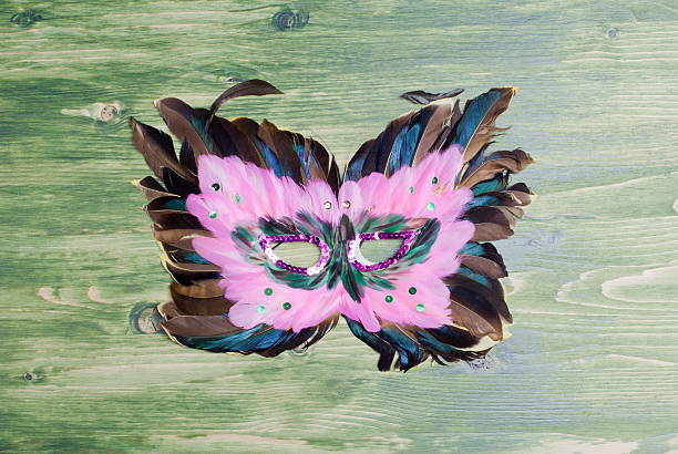 istock beautiful mask of feathers on green blackboard 538070923