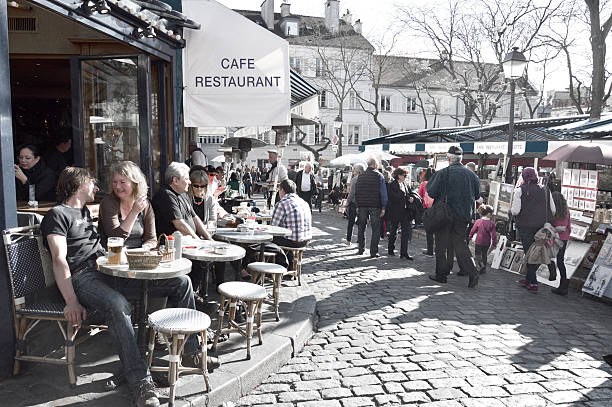 Paris, France - April 20, 2015: Tourists in Place du Tertre in Montmartre, the square is full of restaurants and local artists.