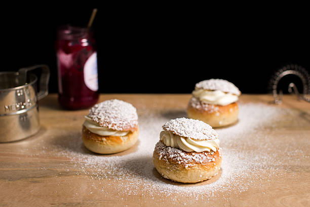 istock Baked buns filled with whipped cream and jam. 538071640