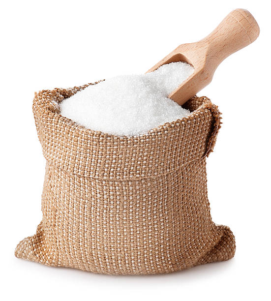 sugar granules with scoop in bag isolated on white background