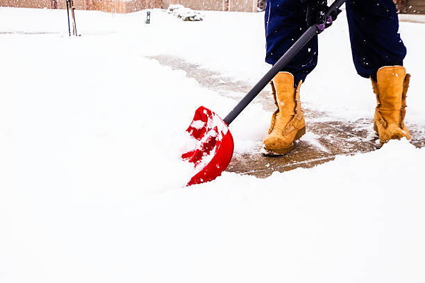 istock Man shoveling snow from driveway in winter storm 538082897