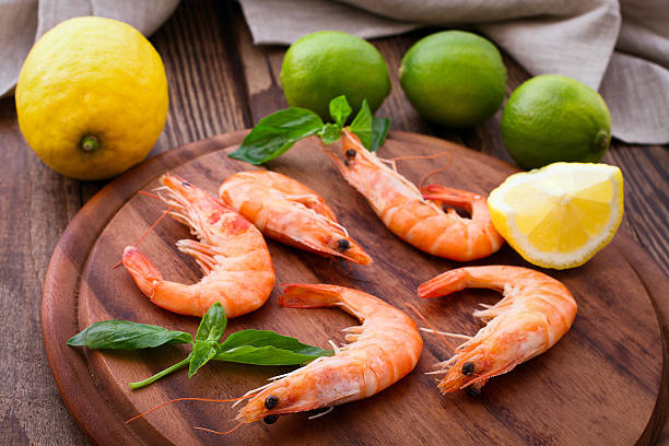 istock Delicious fresh seafood shrimp with lime on wooden table 538083621
