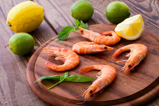 istock Delicious fresh seafood shrimp with lime on wooden table 538083627